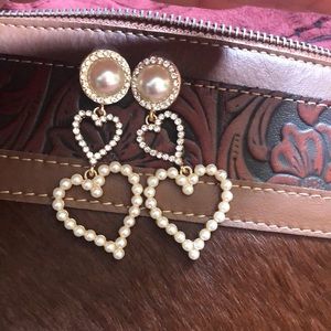 Dangly earrings with hearts, pearls and rhinestones on them.